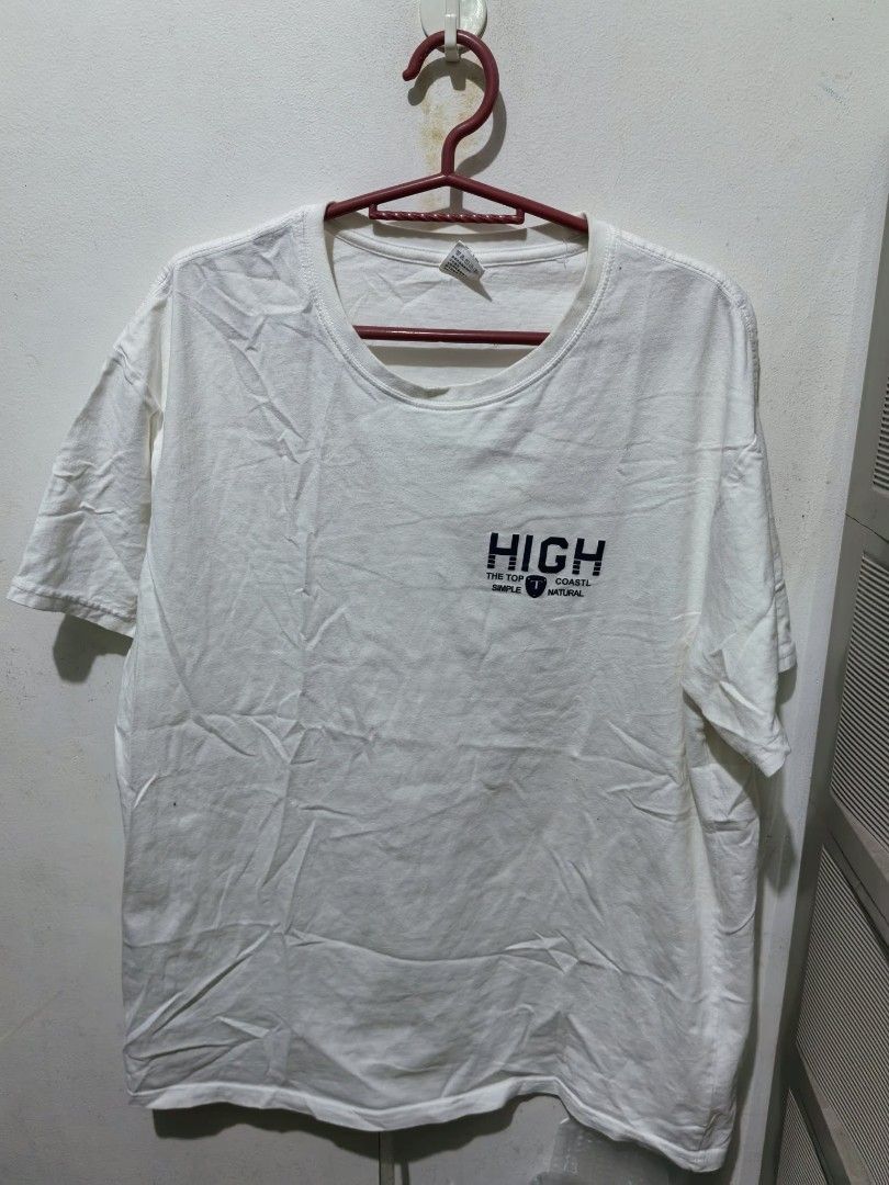 White HIGH Graphic T-Shirt (Category: Shirts) located in Quezon City. Submitted by jasalexiz (Listing ID 1466107612, Image 3). Description: - Color: White - Material: Soft, comfortable cotton - Design: Small dark blue graphic print on chest with shield logo - Cut: Crew neck, short sleeves, relaxed casual fit - Condition: Brand new with standard collar tag - Perfect for daily casual wear.