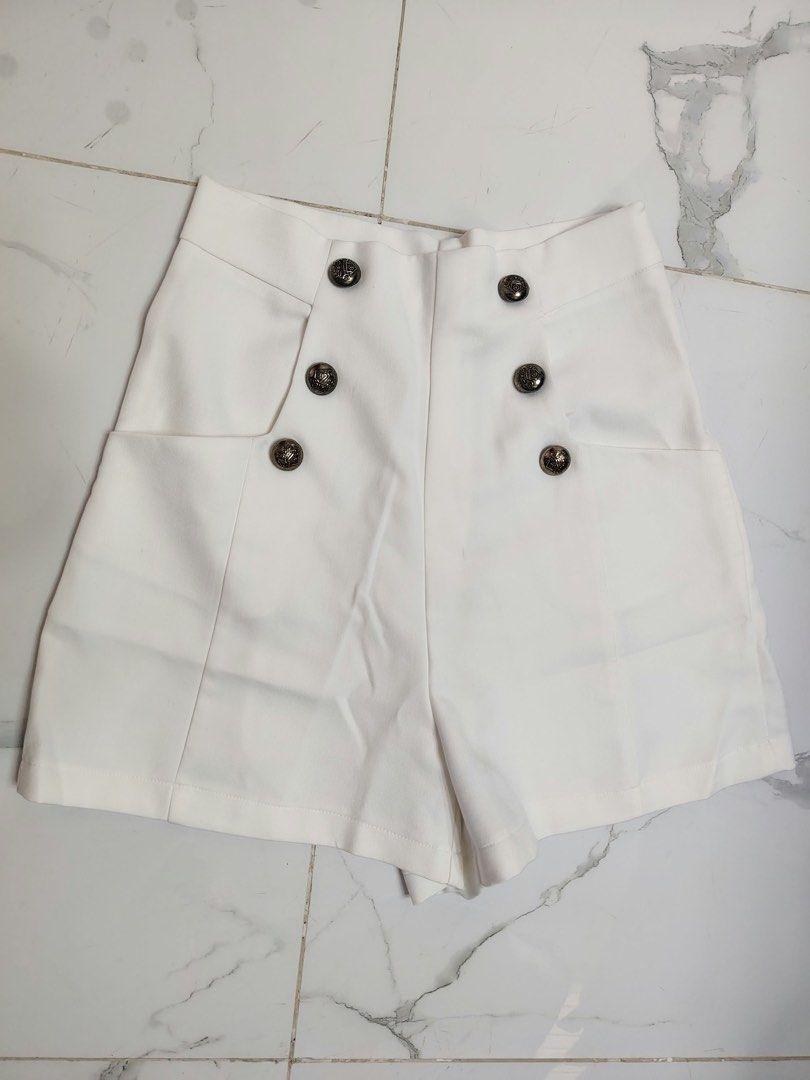 White high waisted shorts with decorative buttons (Category: Shorts) located in Cebu City. Submitted by i_van22 (Listing ID 1466106234, Image 1). Description: - Style: High-waisted white shorts with a clean, tailored back - Details: Eye-catching silver embossed front buttons and convenient side pockets - Material: 100% smooth polyester - Care: Machine washable in cold water - Origin: Made in China.
