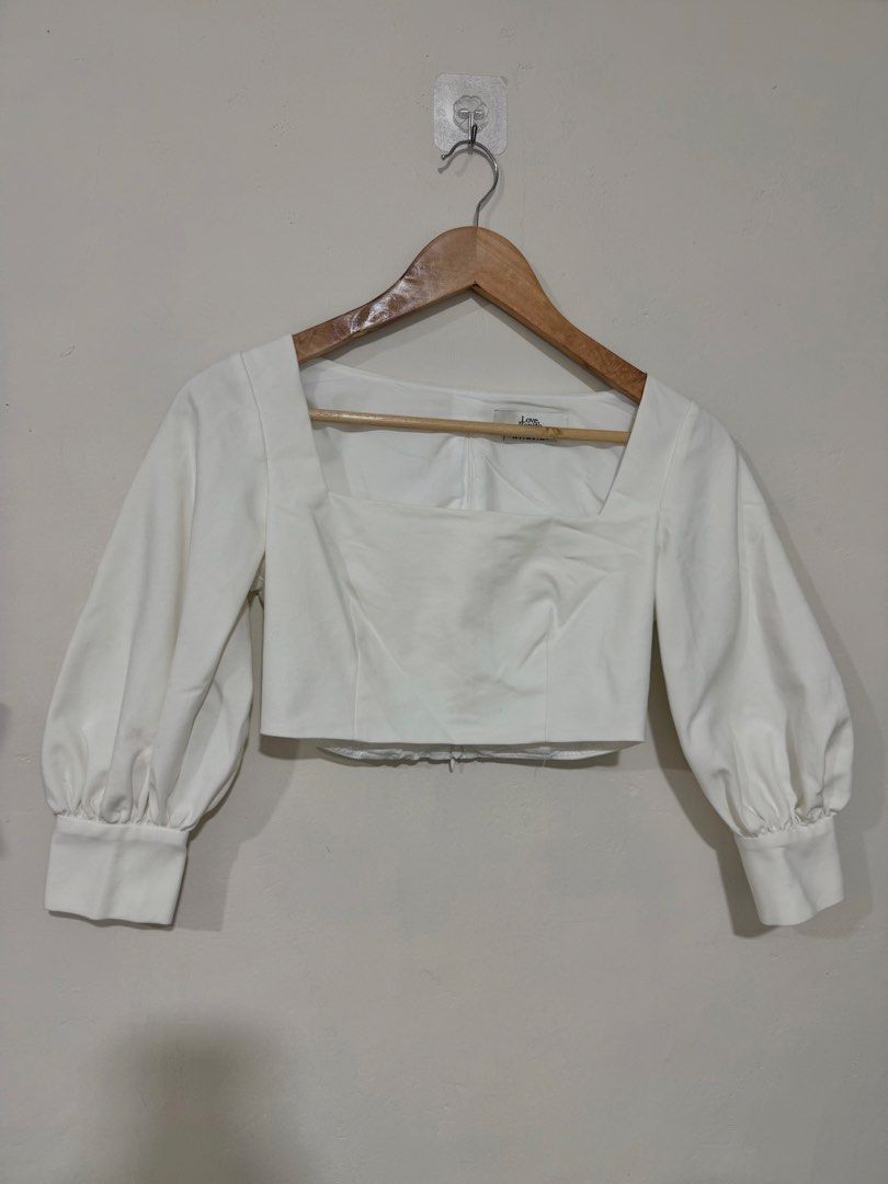 White Love Bonito Square Neck Top (Category: Blouses) located in Manila. Submitted by morningthrifters (Listing ID 1466104923, Image 2). Description: This is the Leana Square Neck Puff Sleeve Top from Love, Bonito, which features a striking square neckline and vintage-inspired puff sleeves. Small on tag Still in very good condition Good as new.