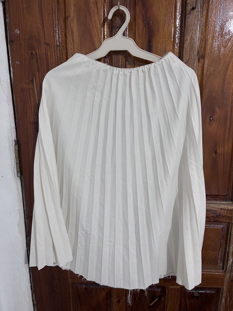 White pleated long sleeve top (Category: Longsleeves) located in Baguio. Submitted by gbwardrobe (Listing ID 1466023122, Image 1). Description: - Color: White - Style: Long-sleeve top with all-over pleated texture - Neckline: Crew neck with gathered details - Fit: Loose and comfortable - Hem: Raw frayed finish - Versatile: Easy to pair with skirts or pants - Condition: Wardrobe cleanout item from a friend.