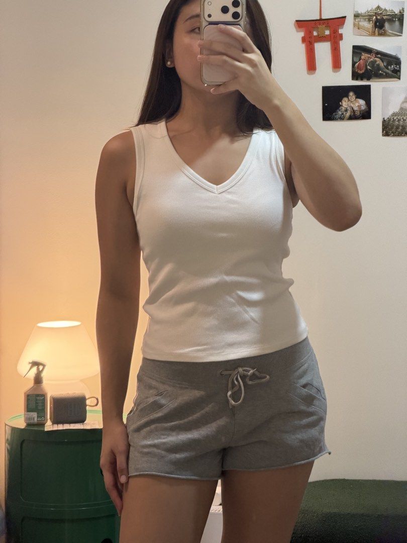 White ribbed V-neck tank top sleeveless basic casual tee (Category: Sleeveless) located in Cebu City. Submitted by wearhousebyhya (Listing ID 1466021605, Image 1). Description: - Color: White - Style: V-neck, slim fit, ribbed texture, PADDED - Material: Comfortable cotton-blend with great stretch - Condition: Clean, no stains, no holes - Versatility: Perfect basic staple for everyday wear, warm weather, or layering.
