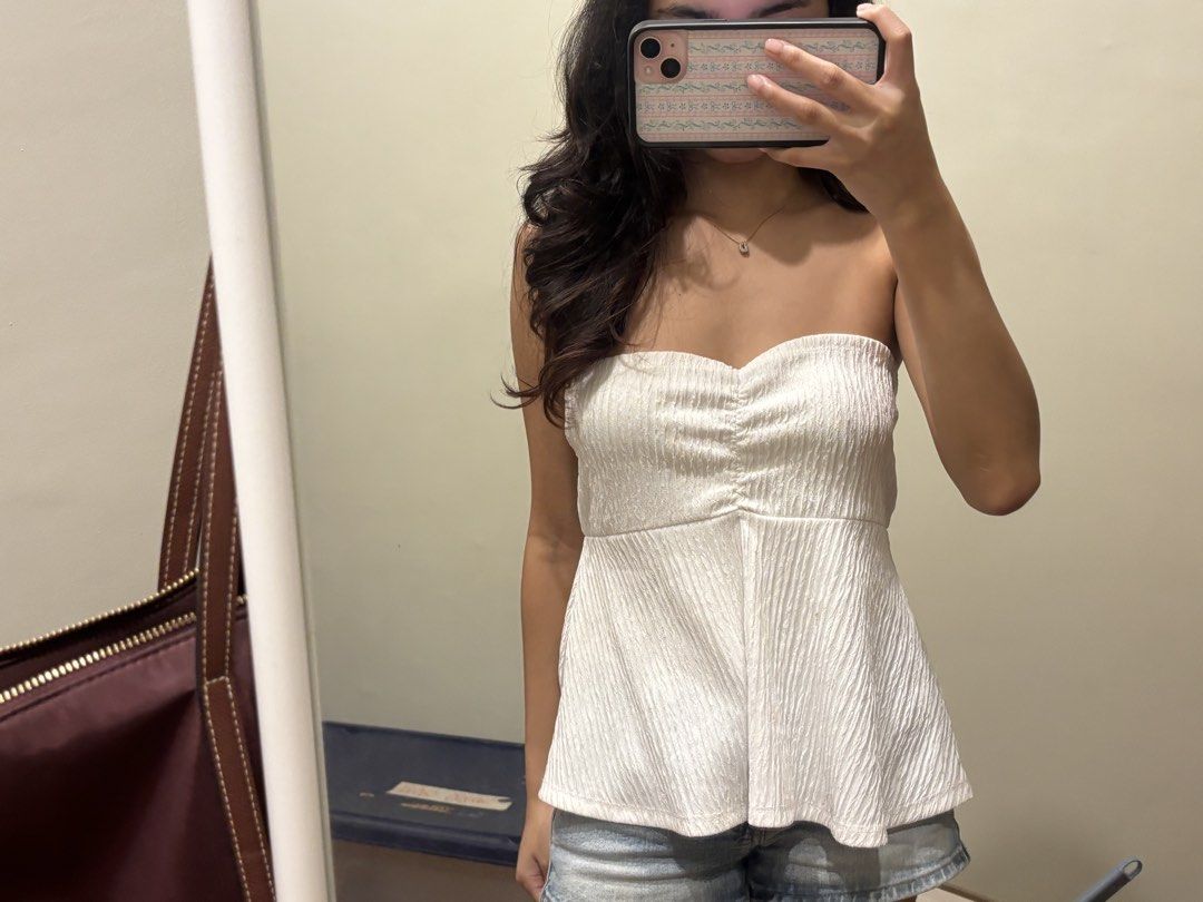 White strapless peplum top (Category: Sleeveless) located in Paranaque City. Submitted by domisclosett (Listing ID 1466094709, Image 3). Description: - Color: White - Style: Strapless tube top with flared peplum hem and gathered front detail - well used but in okay condition - elastic band around the bust area is very well stretched for some reason :/ loc: parañaque/muntinlupa area mop: gcash, maribank, gotyme mod: lalamove or j&t, sf c/o buyer.