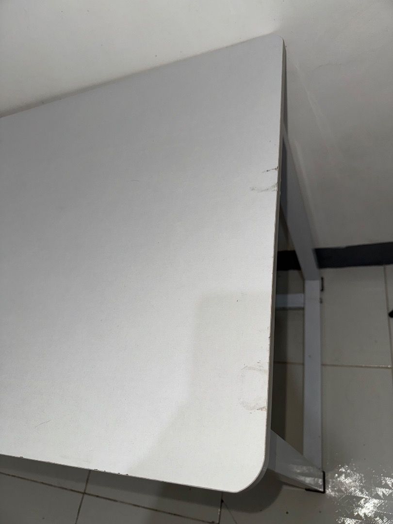 White Study Desk with Metal Frame (Category: Office Furniture & Fixtures) located in Caloocan City. Submitted by freah28000 (Listing ID 1466095018, Image 3). Description: - 120*60*75cm - Color: White with durable metal frame - Design: Clean minimalist style, great for bedrooms or study spaces - Features: Generous surface space for computers and writing tasks - Condition: Stable and sturdy, with minor wear and scuff marks on the surface and edges 