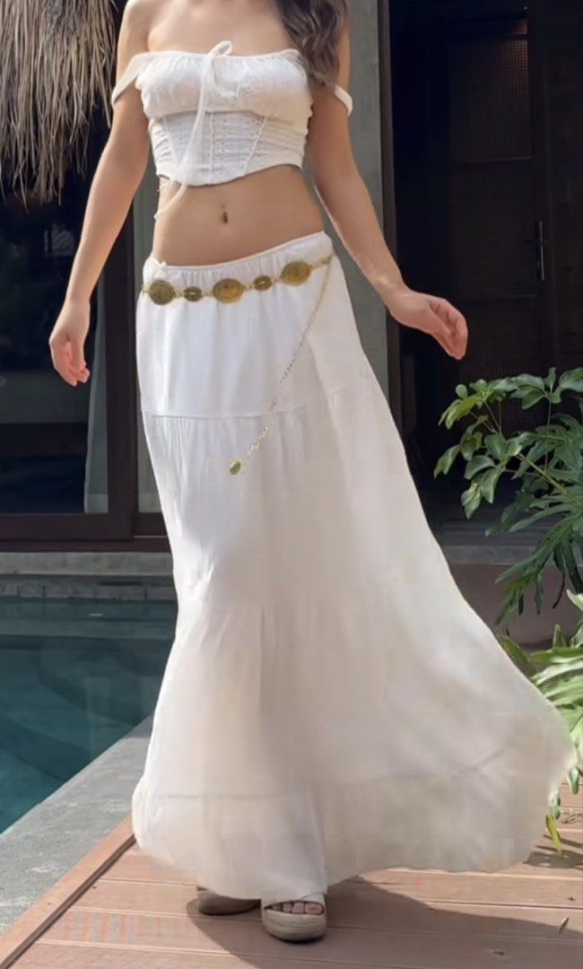 White tiered maxi skirt and top set (Category: Skirts) located in Makati City. Submitted by prelovedloot (Listing ID 1466106883, Image 1). Description: - Style: Low-rise white tiered maxi skirt with a long, flowy fit - Bonus: Includes a stylish thin gold-toned coin chain belt - Comfort: Lightweight fabric that moves beautifully as you walk - Perfect For: Beach trips, vacations, or casual sunny days out - Styling Tip: Looks great paired with a sim