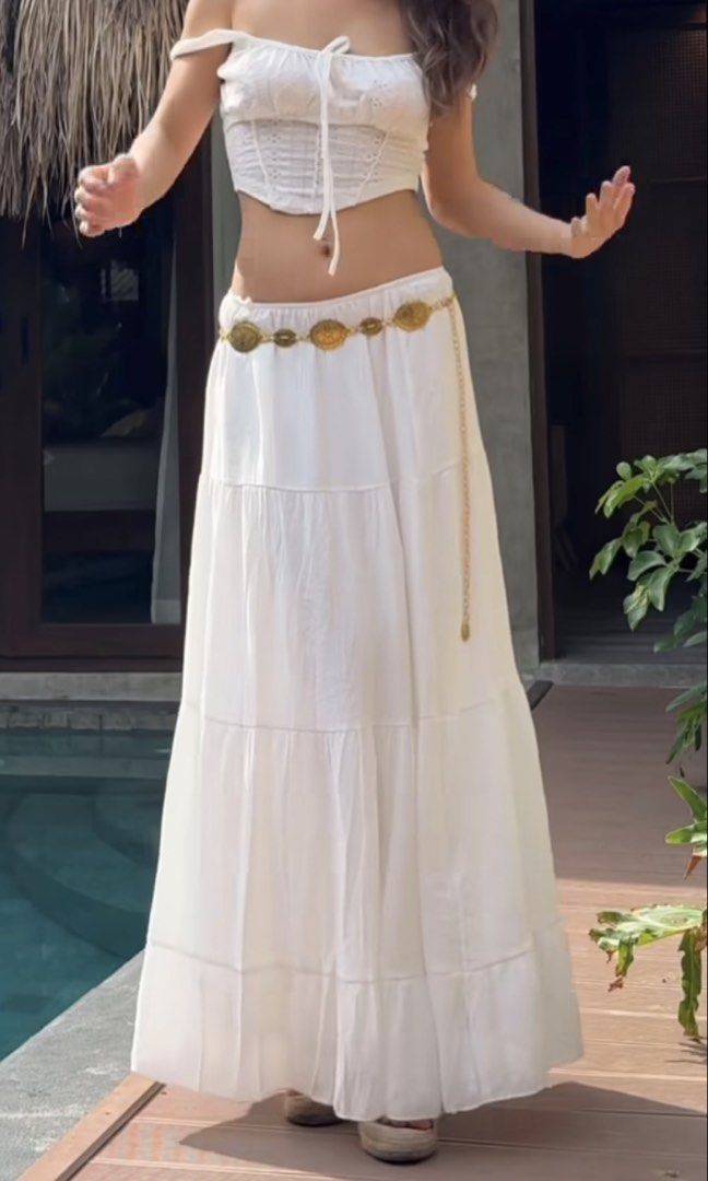 White tiered maxi skirt and top set (Category: Skirts) located in Makati City. Submitted by prelovedloot (Listing ID 1466106883, Image 2). Description: - Style: Low-rise white tiered maxi skirt with a long, flowy fit - Bonus: Includes a stylish thin gold-toned coin chain belt - Comfort: Lightweight fabric that moves beautifully as you walk - Perfect For: Beach trips, vacations, or casual sunny days out - Styling Tip: Looks great paired with a sim