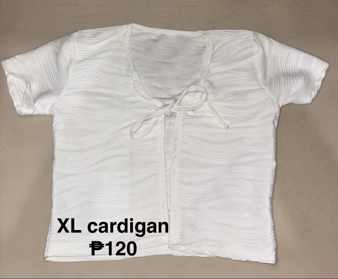 White XL Cardigan (Category: Coats, Jackets and Outerwear) located in Talisay. Submitted by clarelaureano (Listing ID 1466063853, Image 1). Description: - Color: White - Size: XL - Style: Short sleeve open-front cardigan with string ties - Texture: Ribbed material throughout - Features: Versatile layering piece, easy to style for daily wear 💖 Will give discount if buying 2 or more clothes 💖 Can arrange meet-ups depending on availability.