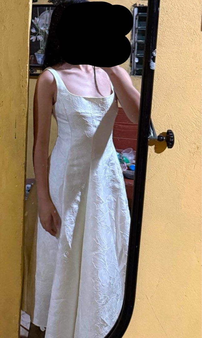 Whoopy Clothing Dress (Category: Dresses) located in Manila. Submitted by ulan_9 (Listing ID 1465955664, Image 2). Description: - Brand: Whoopy Shop - Style: Chelsea Dress (Midi length) - Color: White - Size: Small (EU 36 / UK 8 / US 4) - Details: Structured square neckline, fitted bodice, and full pleated skirt with subtle woven floral jacquard pattern - Condition: Brand new, on hand, and ready to ship - Versatility: Ideal for casual wear or dre