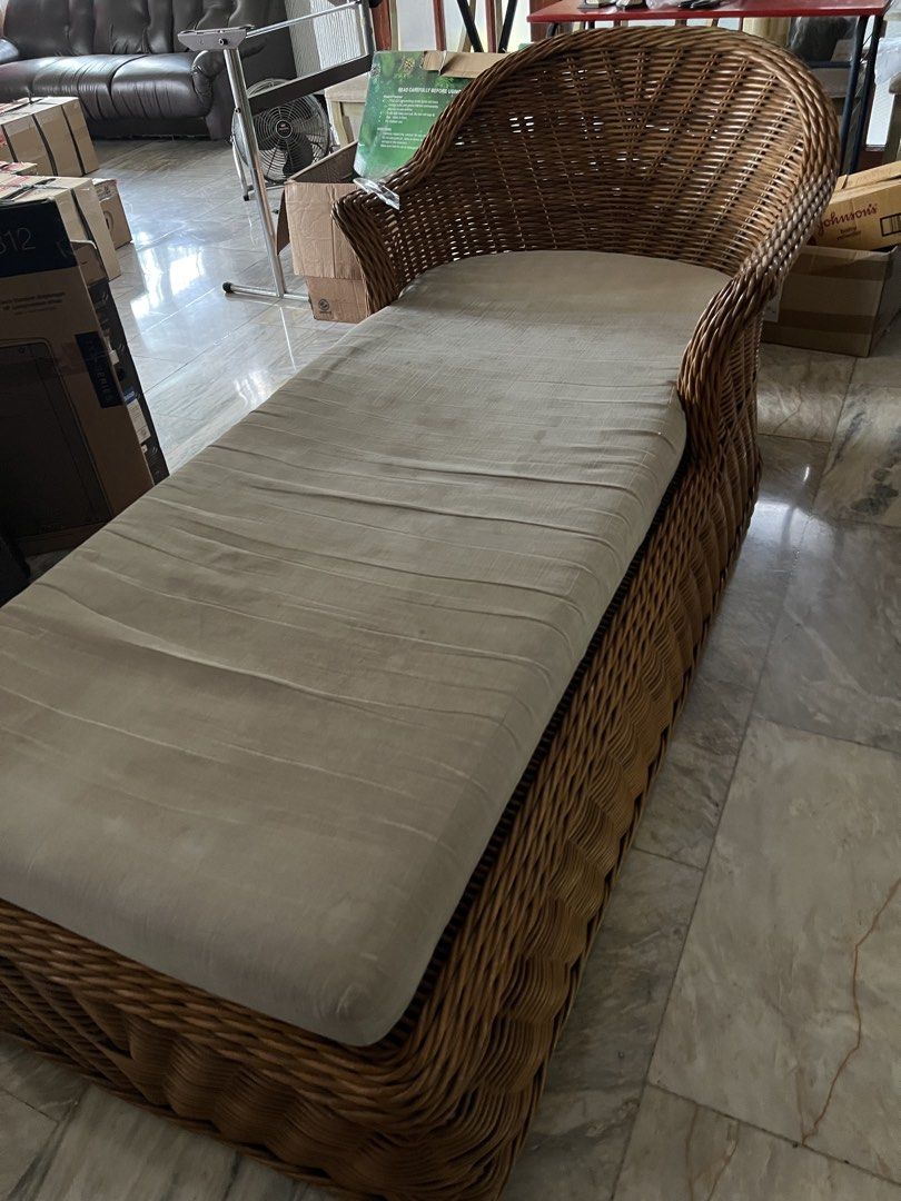 Wicker Chaise Lounge with Cushion (Category: Other Home Furniture) located in Quezon City. Submitted by rmpineda (Listing ID 1466002015, Image 2). Description: - Material: Woven rattan frame with sturdy build - Comfort: Includes a neutral off-white fabric cushion - Design: High curved backrest on one side with a long relaxing seat - Versatility: Neutral tones that fit most living rooms or bedrooms - Condition: Grab it before it's gone!.
