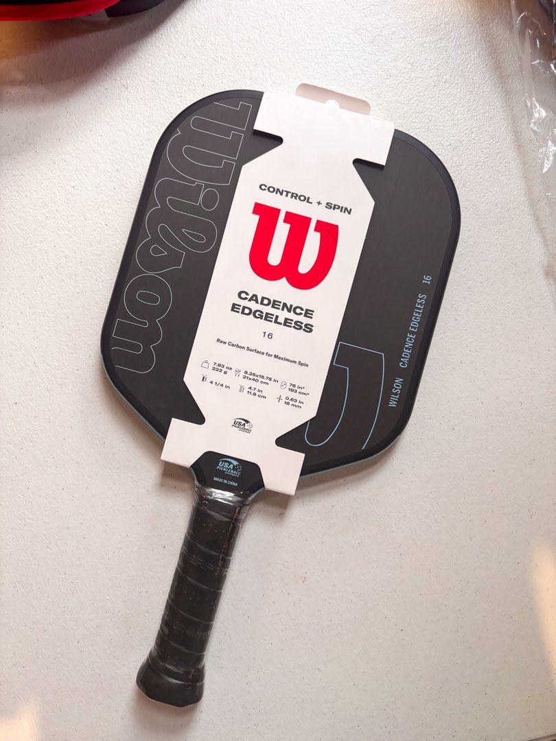 Wilson Cadence Edgeless 16 Pickleball Paddle (Category: Racket and Ball Sports) located in Bacolor. Submitted by tishfinds_ (Listing ID 1466017498, Image 2). Description: - Brand/Model: Wilson Cadence Edgeless 16 Pickleball Paddle - Performance: Designed for control and spin with a raw carbon surface - Weight: 7.83 oz (222 grams) - Dimensions: 8.25 x 15.75 inches - Handle & Grip: 4.7-inch handle length, 4 1/4-inch grip size - Thickness: 0.63 inch