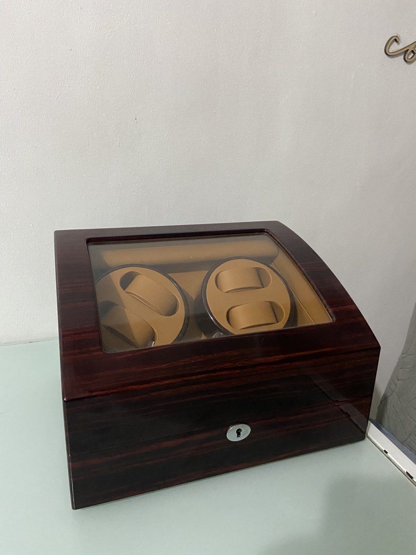 Wooden automatic watch winder box for multiple watches (Category: Men's Watches) located in Makati City. Submitted by mightybear_3ac45c (Listing ID 1465956433, Image 2). Description: - Dark wood grain finish with a sleek glossy coat and tan interior lining - Dual motor modules rotate up to 4 watches simultaneously - Extra storage slots underneath to hold 6 additional watches - Clear glass top display window to showcase your collection - Front key