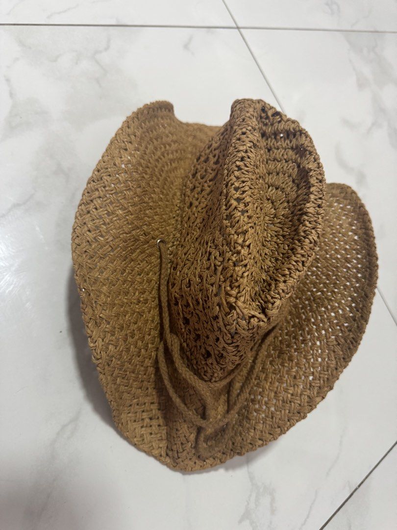 Woven straw cowboy hat with chin strap brown (Category: Caps & Hats) located in Manila. Submitted by decluterthings888 (Listing ID 1465956624, Image 2). Description: - Material: 100% paper straw with an open weave for maximum breathability - Design: Classic brown cowboy hat style with a matching braided chin cord and tassel details - Comfort: Built-in interior sweatband for a snug and comfy fit all day long - Best For: Beach trips, music festival