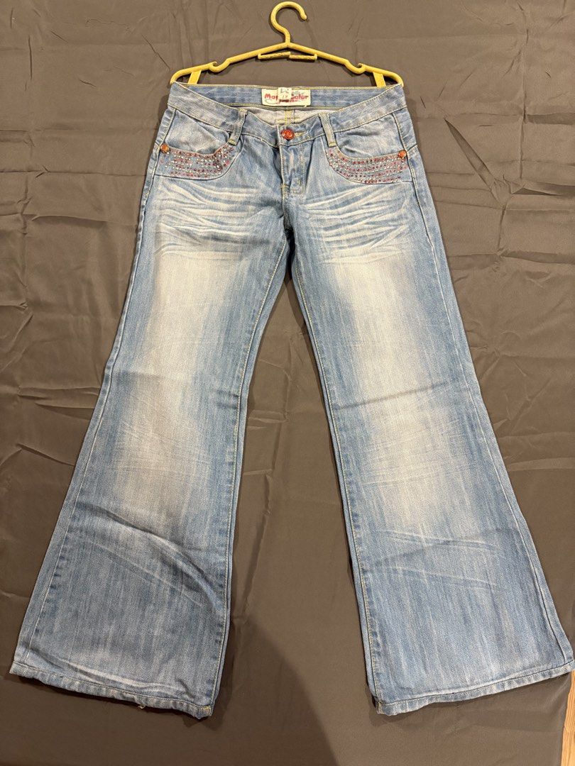 Y2k Low waisted Flare Pants (Category: Jeans) located in Quezon City. Submitted by hannahhhhssclosetttt (Listing ID 1466028890, Image 1). Description: - Back Details: Embroidered red flame/tribal designs with matching rhinestones - Vibe: Fun Y2K statement piece - waist 27/28 inches -length 35.5 inches .