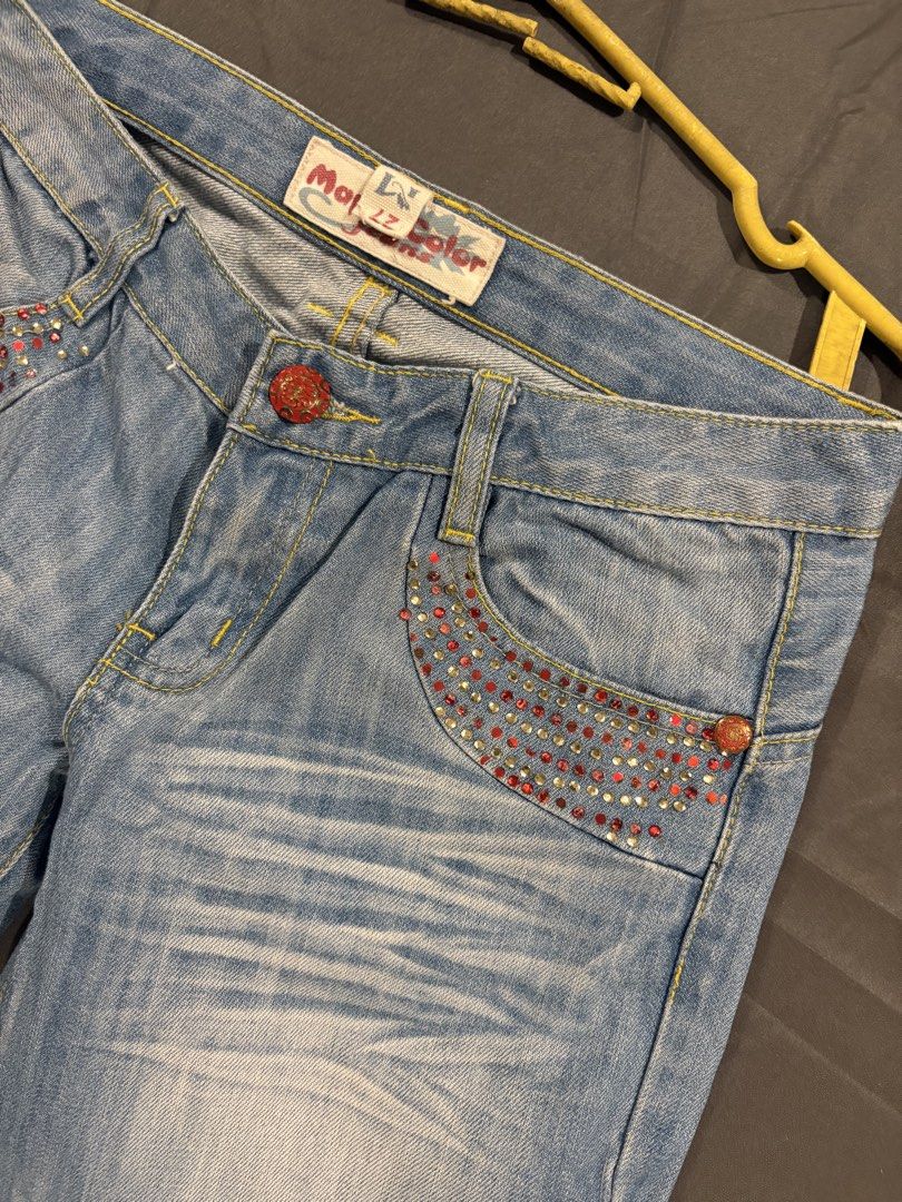 Y2k Low waisted Flare Pants (Category: Jeans) located in Quezon City. Submitted by hannahhhhssclosetttt (Listing ID 1466028890, Image 2). Description: - Back Details: Embroidered red flame/tribal designs with matching rhinestones - Vibe: Fun Y2K statement piece - waist 27/28 inches -length 35.5 inches .