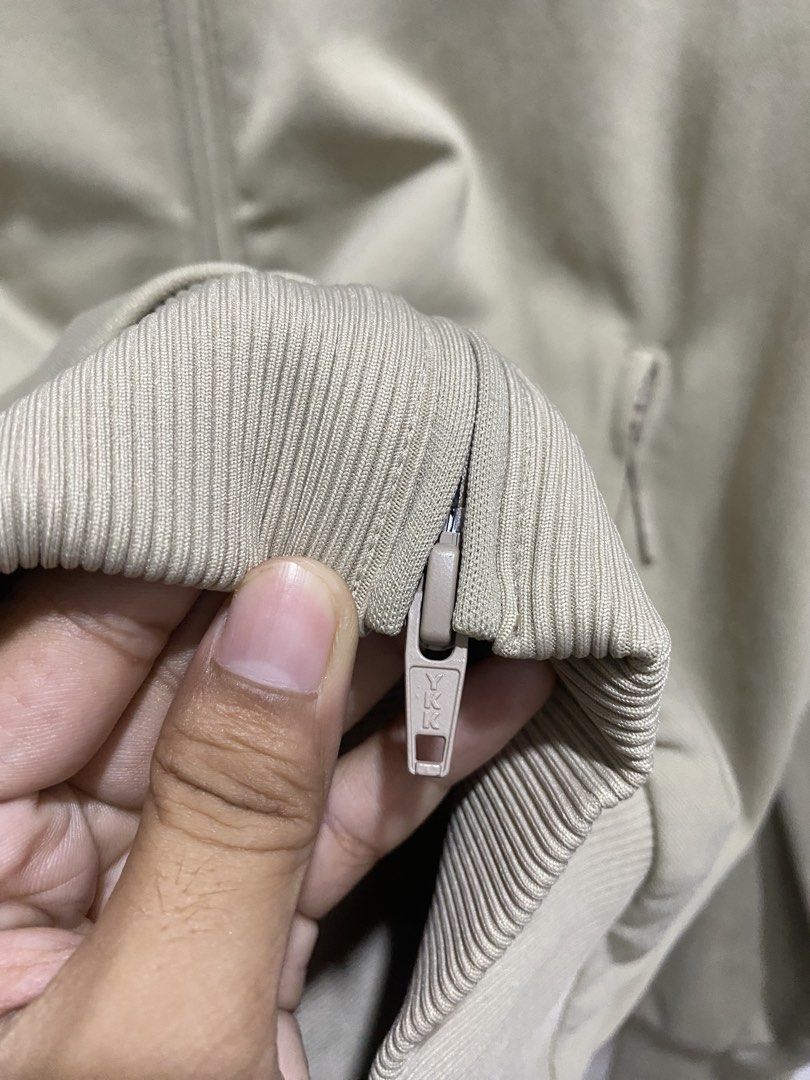 Y-3 Adidas Full Zip Track Jacket Beige Size M (Category: Coats, Jackets and Outerwear) located in Manila. Submitted by hell_market (Listing ID 1466119143, Image 3). Description: Beige Y-3 full zip track jacket by Yohji Yamamoto. Large bright orange Y-3 logo printed across the back. Stand-up collar, ribbed hem, ribbed cuffs, and zippered side pockets. YKK zippers. Made in China. Main material 100% polyamide, ribbing 88% polyamide and 12% elastane,