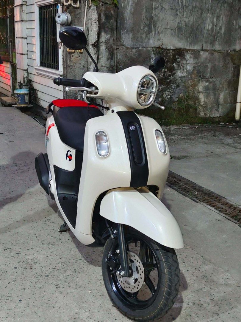 Yamaha Fazzio Scooter White (Category: Motorbikes for Sale) located in Bulacan. Submitted by furnituresantamariabulacan (Listing ID 1466025299, Image 3). Description: - Model: Yamaha Fazzio (Automatic transmission) - Color: White with colorful side stripe decals - Design: Retro round headlight, black seat, and black alloy wheels - Condition: Clean bodywork and exceptionally well-maintained - Performance: Fuel-efficient, perfect for daily commutin