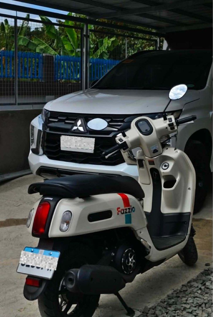 Yamaha Fazzio Scooter White (Category: Motorbikes for Sale) located in Bulacan. Submitted by furnituresantamariabulacan (Listing ID 1466025299, Image 2). Description: - Model: Yamaha Fazzio (Automatic transmission) - Color: White with colorful side stripe decals - Design: Retro round headlight, black seat, and black alloy wheels - Condition: Clean bodywork and exceptionally well-maintained - Performance: Fuel-efficient, perfect for daily commutin