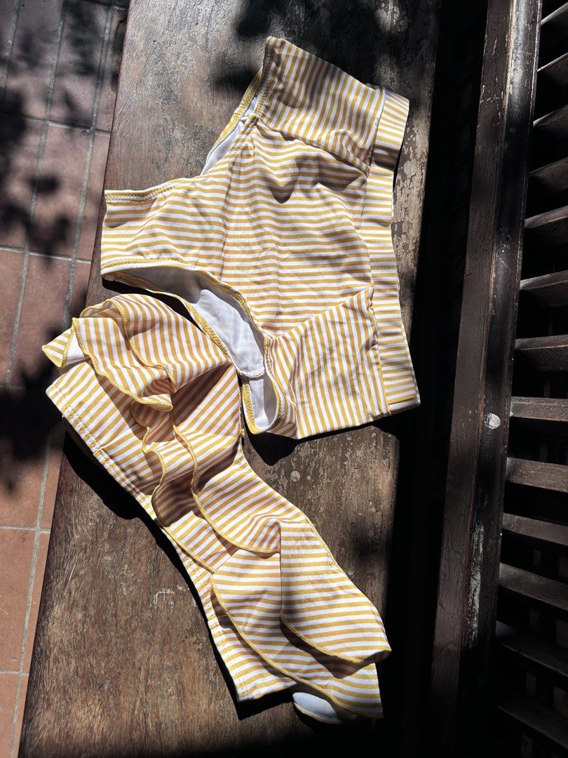 Yellow and white striped ruffle bikini set two piece (Category: Bikinis & Swimsuits) located in Makati City. Submitted by hzsans92 (Listing ID 1466101798, Image 1). Description: - Yellow and white striped bikini set - High-waisted bottoms with a comfortable wide waistband - Matching top with dramatic cascading ruffles - Stretchy, high-quality fabric with white inner lining - Perfect fun summer look for the beach or pool - Got it as medium but fit