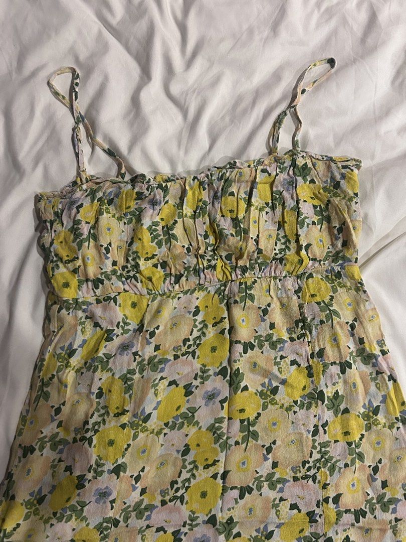 Mango Yellow Floral Midi Dress (Category: Dresses) located in Cebu City. Submitted by shopmikascloset (Listing ID 1466056797, Image 3). Description: - Color & Pattern: Mango yellow with all-over floral print - Design: Spaghetti straps, square neckline, and gathered ruffling across the bust - Fit & Length: Comfortable fit, lightweight fabric, midi length - Size: EUR M / USA S - Perfect for: Sunny days, beach trips, and casual hangouts.