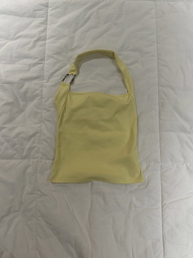 Yellow Halter Top (Category: Sleeveless) located in Manila. Submitted by harleyscloset (Listing ID 1466074159, Image 1). Description: - Soft pastel yellow - Halter-style neckline - Silver ring hardware detail - Asymmetrical strap design - Fitted silhouette .