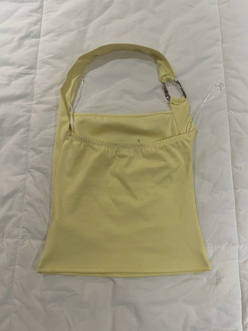 Yellow Halter Top (Category: Sleeveless) located in Manila. Submitted by harleyscloset (Listing ID 1466074159, Image 2). Description: - Soft pastel yellow - Halter-style neckline - Silver ring hardware detail - Asymmetrical strap design - Fitted silhouette .