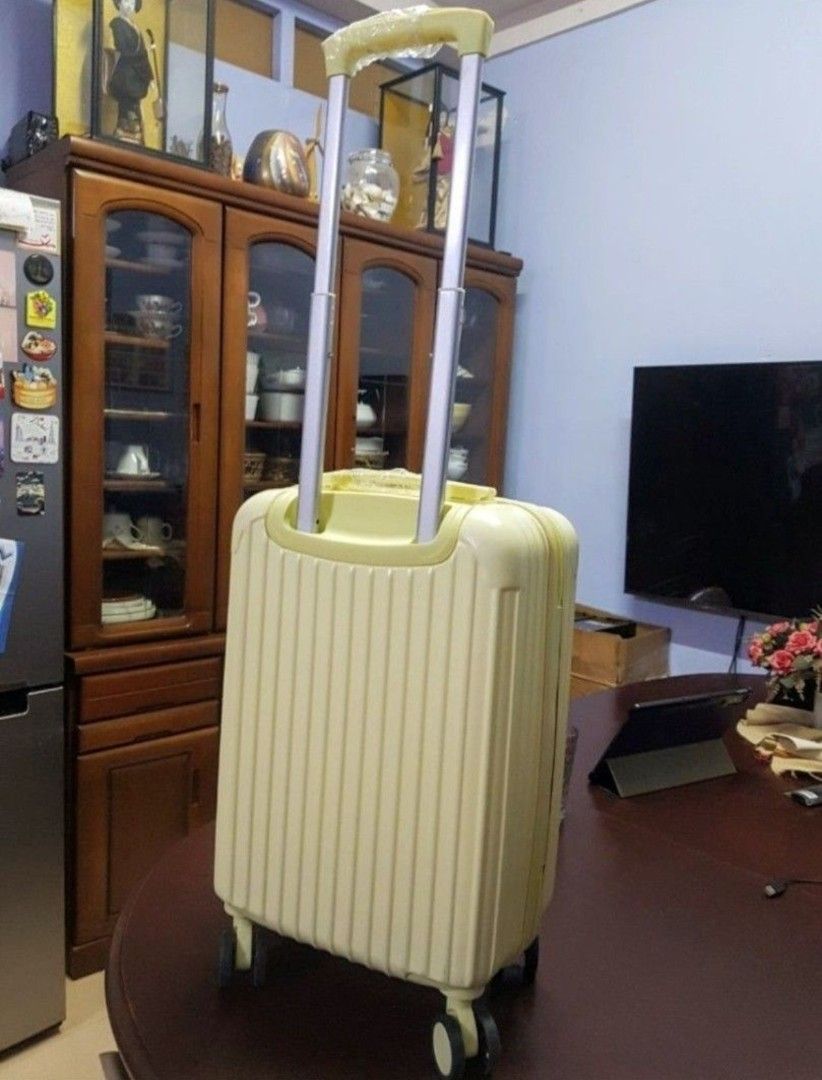Yellow Hardside Spinner Luggage With Retractable Handle (Category: Luggage) located in Quezon City. Submitted by gadgetsun (Listing ID 1466154294, Image 2). Description: - Vibrant yellow hardside suitcase with a stylish vertical ribbed design - Compact cabin size, ideal for weekend trips and short flights - Smooth-rolling 4-wheel swivel base for easy maneuverability - Telescopic dual-tube handle with protective plastic wrapping still intact on th