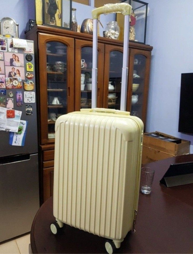 Yellow Hardside Spinner Luggage With Retractable Handle (Category: Luggage) located in Quezon City. Submitted by gadgetsun (Listing ID 1466154294, Image 1). Description: - Vibrant yellow hardside suitcase with a stylish vertical ribbed design - Compact cabin size, ideal for weekend trips and short flights - Smooth-rolling 4-wheel swivel base for easy maneuverability - Telescopic dual-tube handle with protective plastic wrapping still intact on th