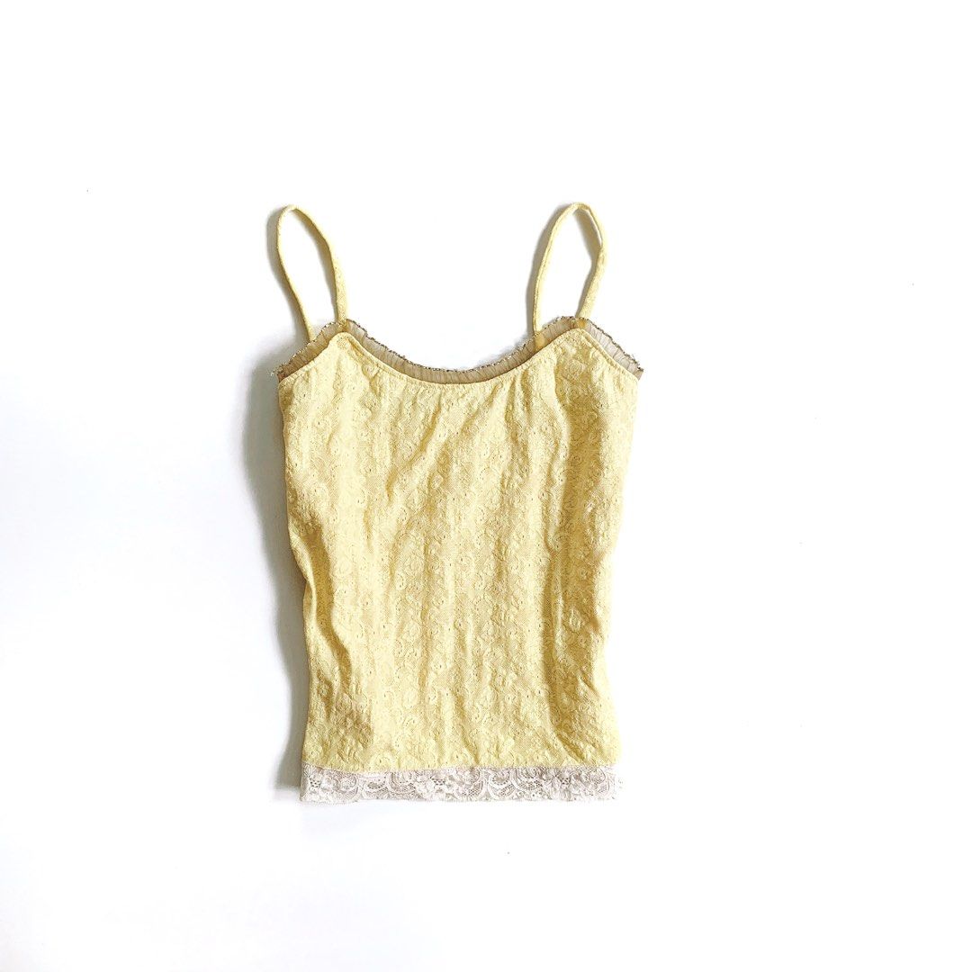 Yellow Lace Trim Cami Tank Top (Category: Sleeveless) located in Tarlac. Submitted by luv__vintage (Listing ID 1466048976, Image 2). Description: - Color/Pattern: Soft yellow with all-over floral lace texture - Details: Scalloped neckline with brown ruffle trim and contrast white lace hem - Fit & Material: Slim fit, stretchy, with adjustable spaghetti straps - Styling: Perfect for layering under cardigans or pairing with skirts and denim - Condit