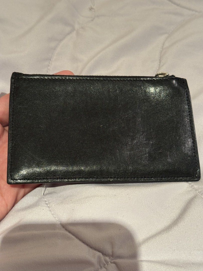 YSL Yves Saint Laurent slim wallet (Category: Wallets & Card Holders) located in Pasay City. Submitted by iflyph (Listing ID 1466155129, Image 2). Description: - Authentic YSL wallet - Zip-around closure - Black textured leather - Bill/Coin/card storage 8/10 condition guaranteed authentic or money back no return no exchange.
