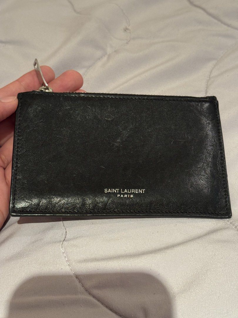 YSL Yves Saint Laurent slim wallet (Category: Wallets & Card Holders) located in Pasay City. Submitted by iflyph (Listing ID 1466155129, Image 1). Description: - Authentic YSL wallet - Zip-around closure - Black textured leather - Bill/Coin/card storage 8/10 condition guaranteed authentic or money back no return no exchange.