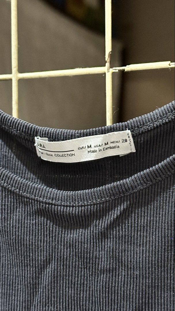 Zara Basic Collection Gray Ribbed Tank Top Medium (Category: Sleeveless) located in Quezon City. Submitted by nsseller (Listing ID 1466109005, Image 2). Description: - Brand: Zara Basic Collection - Size: EUR M / USA M / MEX 28 - Material: Soft ribbed cotton blend (Made in Cambodia) - Design: Scoop neck with thin shoulder straps - Fit: Standard length, easy to style for casual wear.
