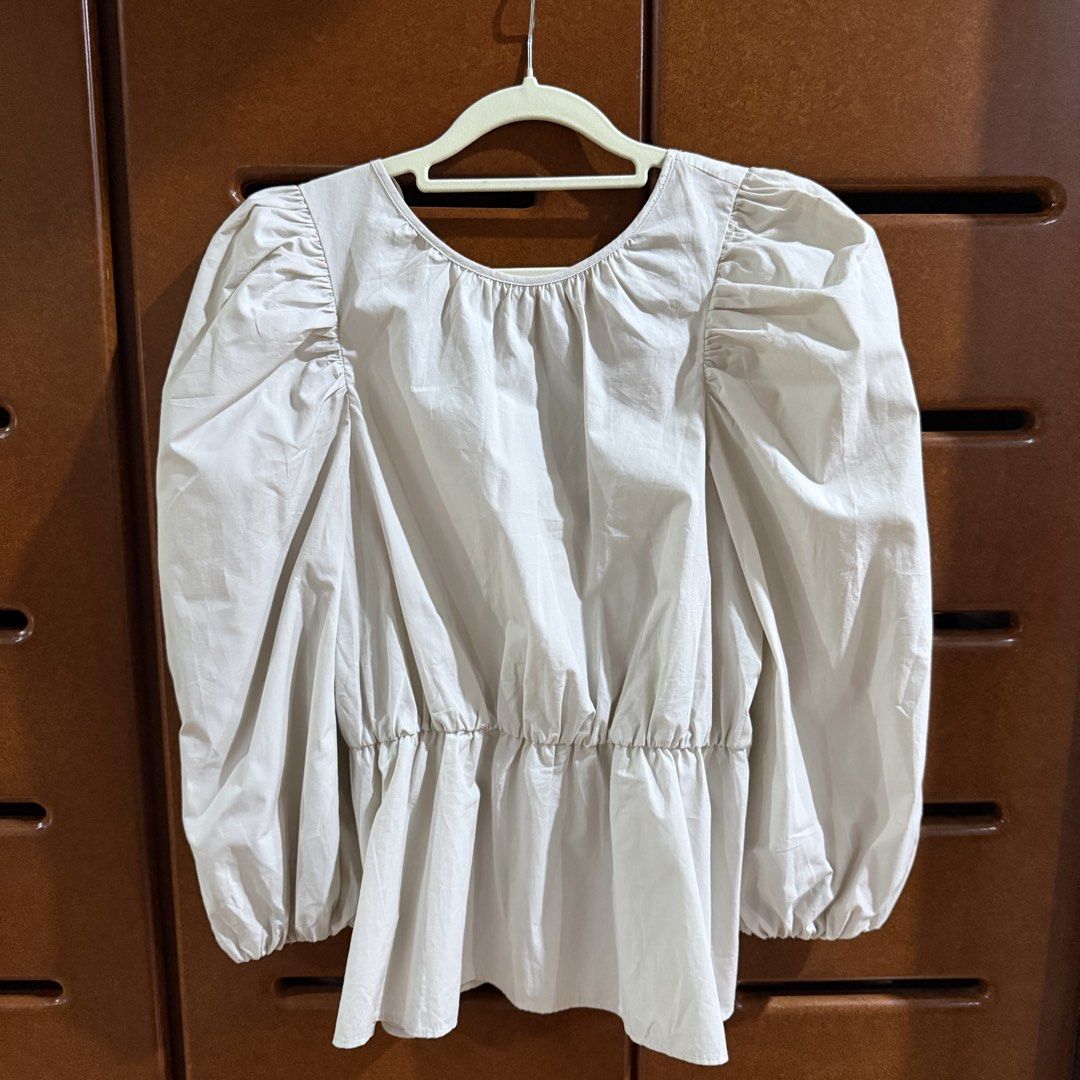 ZARA Beige Blouse Size S (Category: Blouses) located in Davao. Submitted by keirousel (Listing ID 1466041719, Image 1). Description: - Brand: ZARA - Size: S (Made in Morocco) - Color: Classic Beige - Material: Textured cotton - Details: Long puff sleeves with elastic cuffs - Fit: Elasticized waist for a flattering peplum shape - Back: Charming string ties across the neckline.