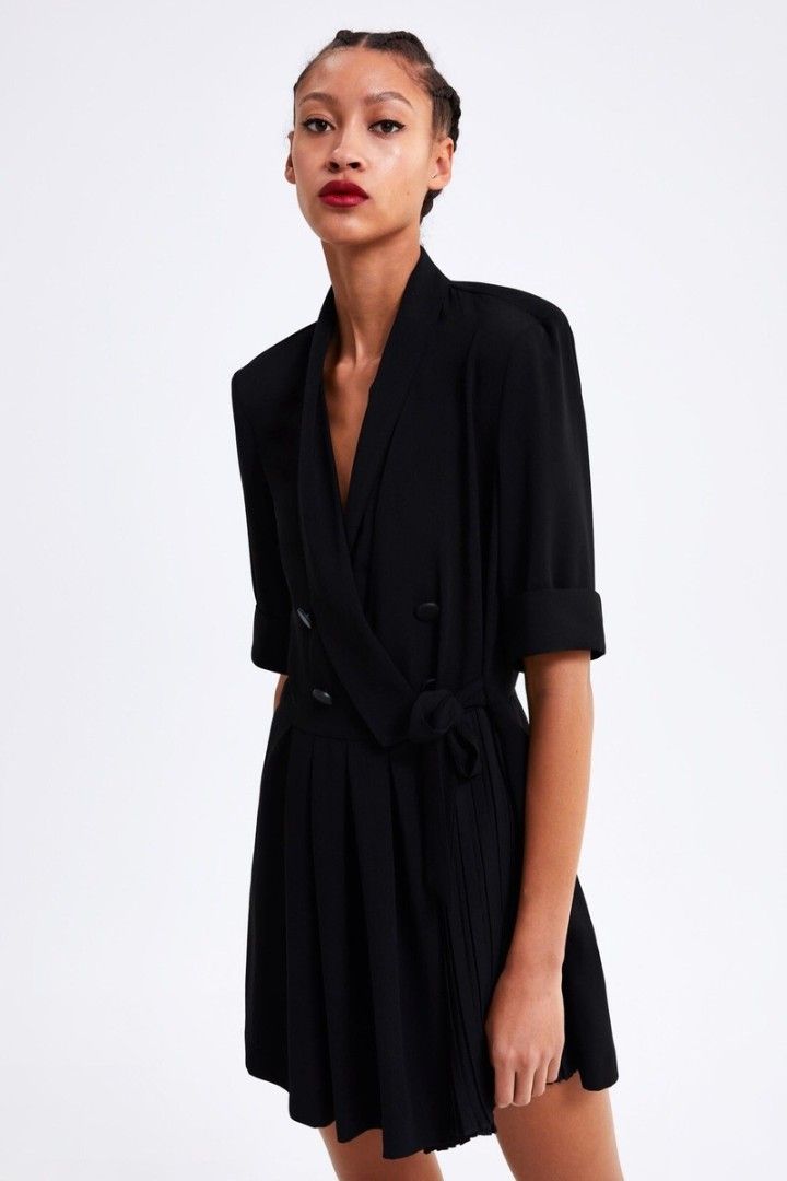 Zara Black Blazer Romper Size S (Category: Rompers) located in Quezon City. Submitted by corrnic (Listing ID 1466064737, Image 1). Description: - Brand: Zara - Size: S (Made in Turkey) - Color: Black - Style: Double-breasted blazer dress with a shawl collar - Details: Folded short sleeves, tie belt at the waist, and pleated skirt detail - Length: Knee-length - Condition: Excellent with clean interior tags - Perfect for a professional yet chic loo