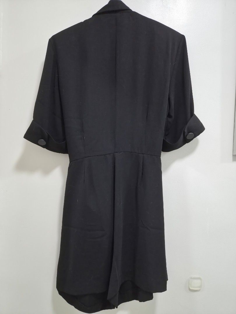 Zara Black Blazer Romper Size S (Category: Rompers) located in Quezon City. Submitted by corrnic (Listing ID 1466064737, Image 3). Description: - Brand: Zara - Size: S (Made in Turkey) - Color: Black - Style: Double-breasted blazer dress with a shawl collar - Details: Folded short sleeves, tie belt at the waist, and pleated skirt detail - Length: Knee-length - Condition: Excellent with clean interior tags - Perfect for a professional yet chic loo