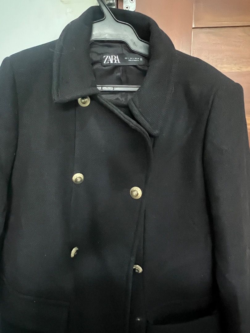 Zara Black Coat Double Breasted Gold Buttons (Category: Coats, Jackets and Outerwear) located in Pasay City. Submitted by sharshay317 (Listing ID 1465998080, Image 1). Description: Zara black coat in size large, made in Morocco. Double-breasted front closure featuring shiny gold-toned buttons. Two front patch pockets at the waist level. Classic collar design and lined interior. Good solid weight for cooler weather. Clean lines and simple silhouet