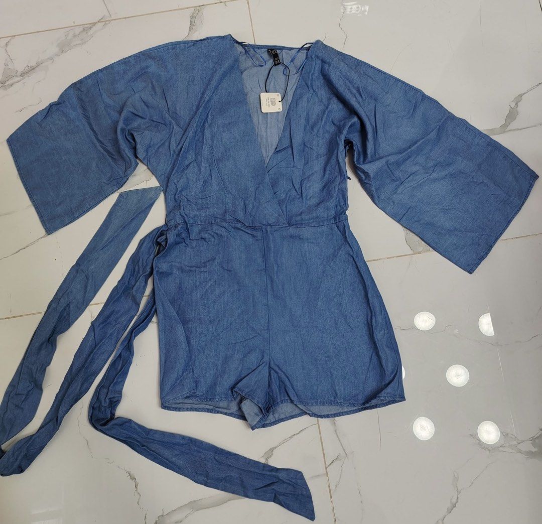 Zara TRF Denim Romper Size M (Category: Rompers) located in Cebu City. Submitted by i_van22 (Listing ID 1466107201, Image 2). Description: Zara TRF denim romper in medium blue wash. V-neck wrap front style with wide flared sleeves and matching waist tie belt. Made in Morocco. Size EUR M, USA M, MEX 28. Original tags still attached..