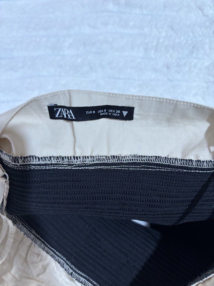 Zara Two-Tone Ruffled Camisole Top Size S (Category: Sleeveless) located in Quezon City. Submitted by hadescloset (Listing ID 1465956974, Image 3). Description: - Used once - Brand: Zara - Size: S (tag attached) - Color: Beige and black - Material: Cotton and elastane blend - Features: Adjustable shoulder straps, ruched ruffle cups, stretchy smocked lower section, side zipper closure - Condition: Clean inside and out, great casual piece for warme