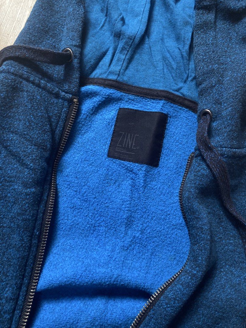 Zine Blue Zip-Up Hoodie (Category: Coats, Jackets and Outerwear) located in Tanauan. Submitted by rie098 (Listing ID 1466041470, Image 3). Description: - Color: Dark blue heather with bright blue interior lining - Closure: Full zipper - Pockets: Front split kangaroo pocket - Details: Contrasting drawstrings, ribbed cuffs and hem - Fit: Standard fit - Ideal for: Cooler weather layering.