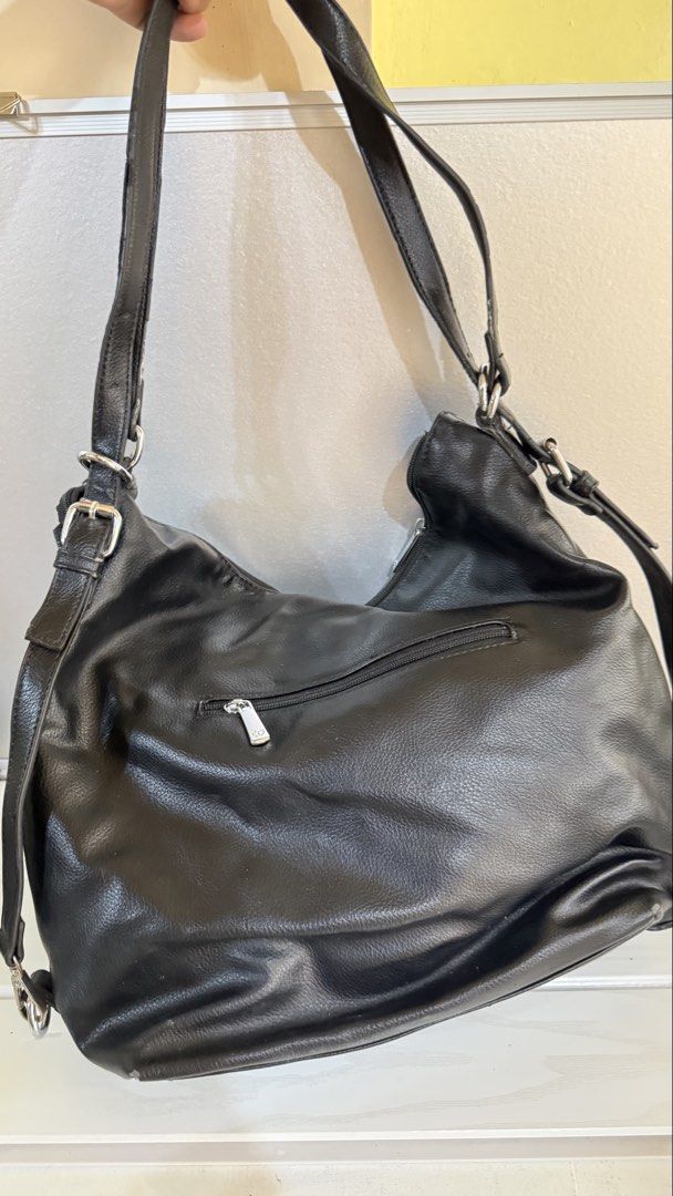 2-way shoulder/back pack (Category: Shoulder Bags) located in Manila. Submitted by oddwolf.aa8f19 (Listing ID 1466185435, Image 3). Description: - Brand: MICHAELA - Color: Classic Black - Style: 2-way versatile design (can be worn as a shoulder bag or backpack) - Material: Soft faux leather with textured finish - Compartments: Multiple exterior zippered pockets for easy organization - Straps: Adjustable straps with sturdy metal hardware - Conditi