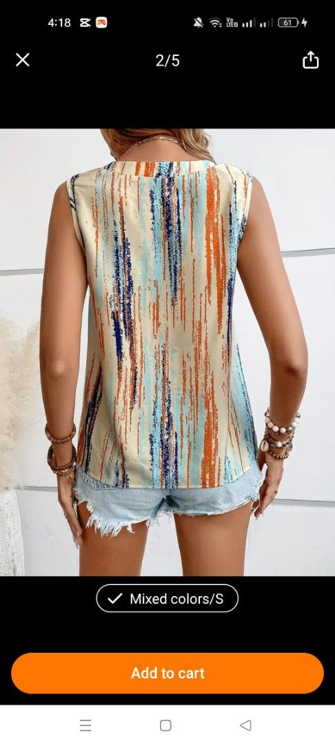 Abstract Striped Button-Front Tank Top (Category: Sleeveless) located in Mandaluyong City. Submitted by zheida1068 (Listing ID 1466297404, Image 3). Description: - Design: Abstract vertical stripe pattern in vibrant orange, blue, and cream - Style: Sleeveless with a classic round neckline and partial 4-button front - Comfort: Lightweight fabric, ideal for warm weather - Size: S - Condition: Excellent, ready to wear!.