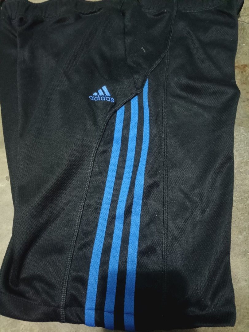 Adidas Black and Blue Athletic Shorts Size S (Category: Shorts) located in Quezon City. Submitted by kramps.23 (Listing ID 1466323213, Image 3). Description: Adidas athletic shorts in black with bright blue side stripes and matching inner waistband. Includes an adjustable drawstring and side pockets. Size small, made in Indonesia. Lightweight fabric, great for workouts or casual wear. Clean condition, ready to wear. Dimes: - waist: 32 - Lenght: 1