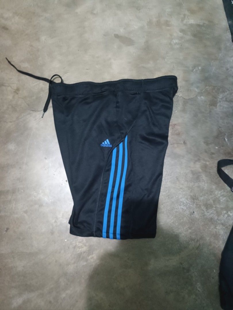 Adidas Black and Blue Athletic Shorts Size S (Category: Shorts) located in Quezon City. Submitted by kramps.23 (Listing ID 1466323213, Image 2). Description: Adidas athletic shorts in black with bright blue side stripes and matching inner waistband. Includes an adjustable drawstring and side pockets. Size small, made in Indonesia. Lightweight fabric, great for workouts or casual wear. Clean condition, ready to wear. Dimes: - waist: 32 - Lenght: 1
