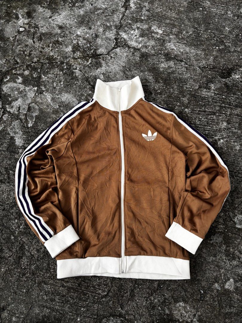 Adidas Brown Track Jacket (Category: Coats, Jackets and Outerwear) located in Caloocan City. Submitted by neweagle-424b (Listing ID 1466209214, Image 1). Description: Dimes - Width : ( 21 - 22 x 27 ) Length - Brand: Adidas - Item: Track Jacket - Color: Brown with white cream andpurple - Size: US XL / Asia XL (185/104A) - Material: 52% Cotton, 48% Polyester (Made in Pakistan) - Features: Full zip closure, ribbed collar/cuffs/hem, classic sleeve st