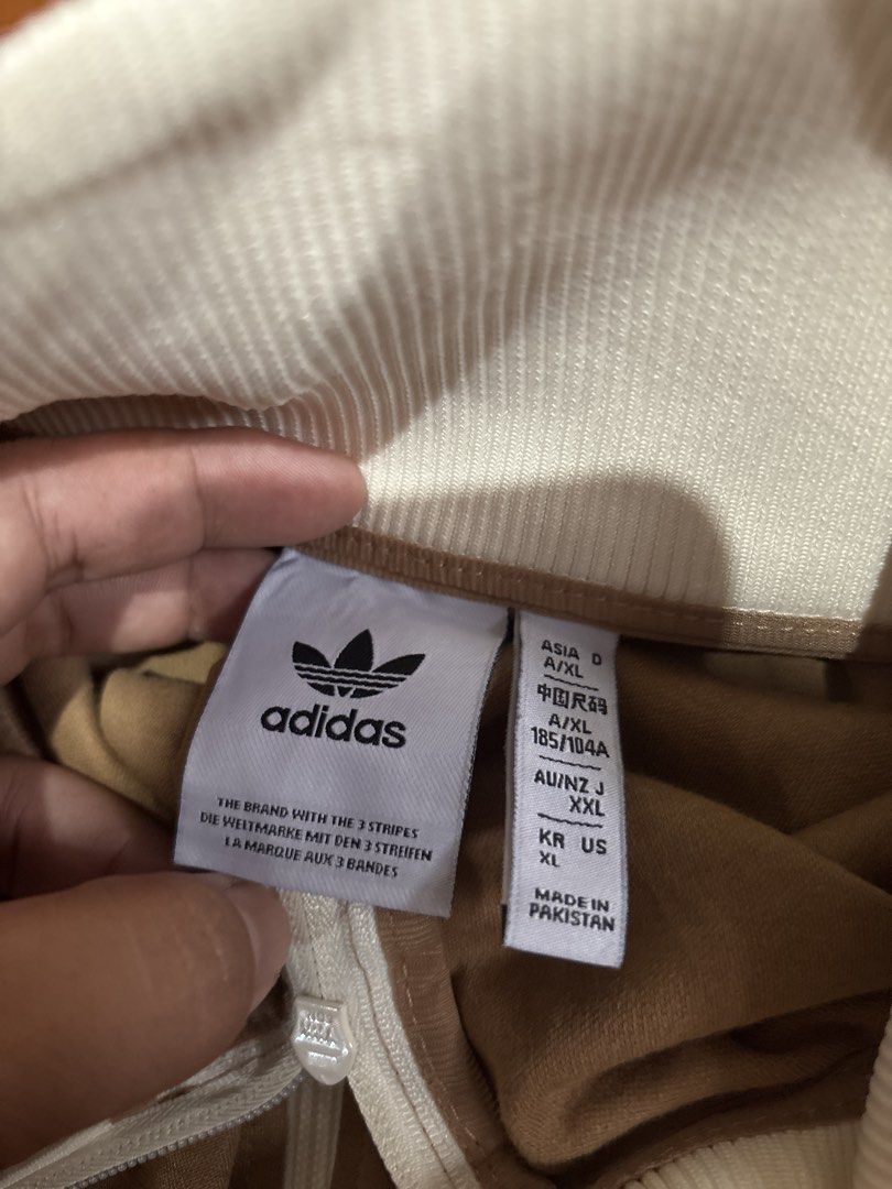 Adidas Brown Track Jacket (Category: Coats, Jackets and Outerwear) located in Caloocan City. Submitted by neweagle-424b (Listing ID 1466209214, Image 2). Description: Dimes - Width : ( 21 - 22 x 27 ) Length - Brand: Adidas - Item: Track Jacket - Color: Brown with white cream andpurple - Size: US XL / Asia XL (185/104A) - Material: 52% Cotton, 48% Polyester (Made in Pakistan) - Features: Full zip closure, ribbed collar/cuffs/hem, classic sleeve st