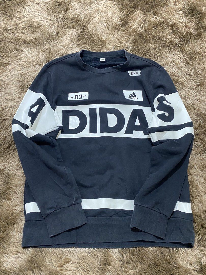 Adidas Graphic Sweatshirt Black White #03 (Category: Coats, Jackets and Outerwear) located in Cagayan de Oro. Submitted by sepamorash53558 (Listing ID 1466328756, Image 1). Description: - Brand: Adidas - Color: Black with bold white logo panels - Design: Features '03' graphic patch on the front - Details: Ribbed collar, cuffs, and hem - Condition: Excellent everyday piece - Style: Classic sportswear for cooler weather.