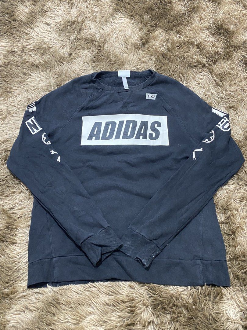 Adidas Neo Black Sweatshirt Size L (Category: Coats, Jackets and Outerwear) located in Cagayan de Oro. Submitted by sepamorash53558 (Listing ID 1466328637, Image 1). Description: - Brand: Adidas Neo - Color: Black - Size: Large (Measures 21" across chest, 27" in length) - Material: 100% Cotton - Design: Large front logo with unique bicycle gear and tool graphics down both sleeves - Details: Ribbed crewneck, cuffs, and hem for a snug fit - Conditi