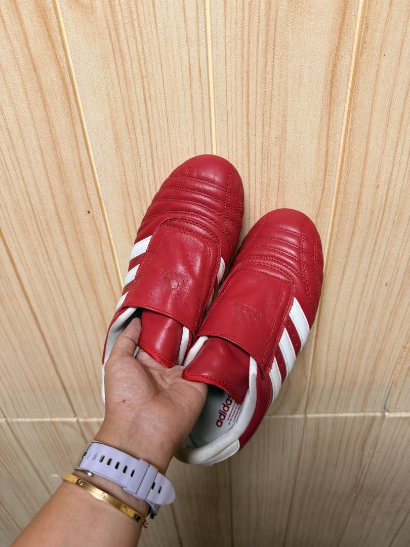 Adidas Taekwondo womens (Category: Sneakers) located in Davao. Submitted by cloie12345 (Listing ID 1466223979, Image 2). Description: Bright red Adidas sneakers in US 6.5 / UK 5 / FR 38. Features white stripes, lace cover flap, and gum soles. Clean condition with minor sole wear..