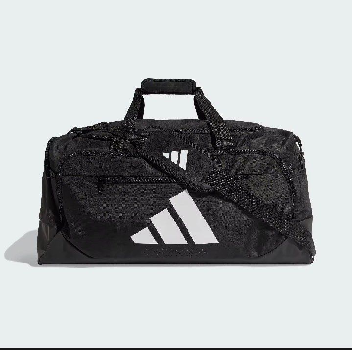 Adidas Training Defense Duffel Bag Medium Black (Category: Sling Bags) located in Manila. Submitted by whenn_1985 (Listing ID 1466288309, Image 2). Description: - Brand new with retail tag (2,000 PHP value) still in original plastic packaging - Color: Classic black with white Adidas logo on the front - Size: Medium, perfect for gym and training gear - Storage: Multiple zippered compartments to keep your items organized - Comfort & Durability: Stu