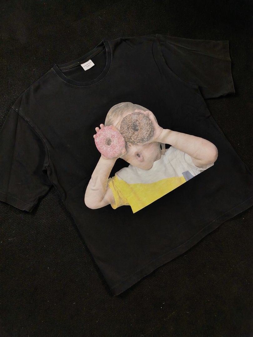 ADLV Donut kid (Category: Tshirts & Polo Shirts ) located in San Fernando. Submitted by gaboo_asncn (Listing ID 1466324781, Image 1). Description: - ADLV Donut kid - Size: Large (W22.5/L27) - Condition: Good - Color Rate: 8.5/10 - No Issue Take note: The shirt is black, and since the carpet/background is also black, the color may look slightly faded or less vibrant in the photos. In actual lighting, the shirt has a normal black color..