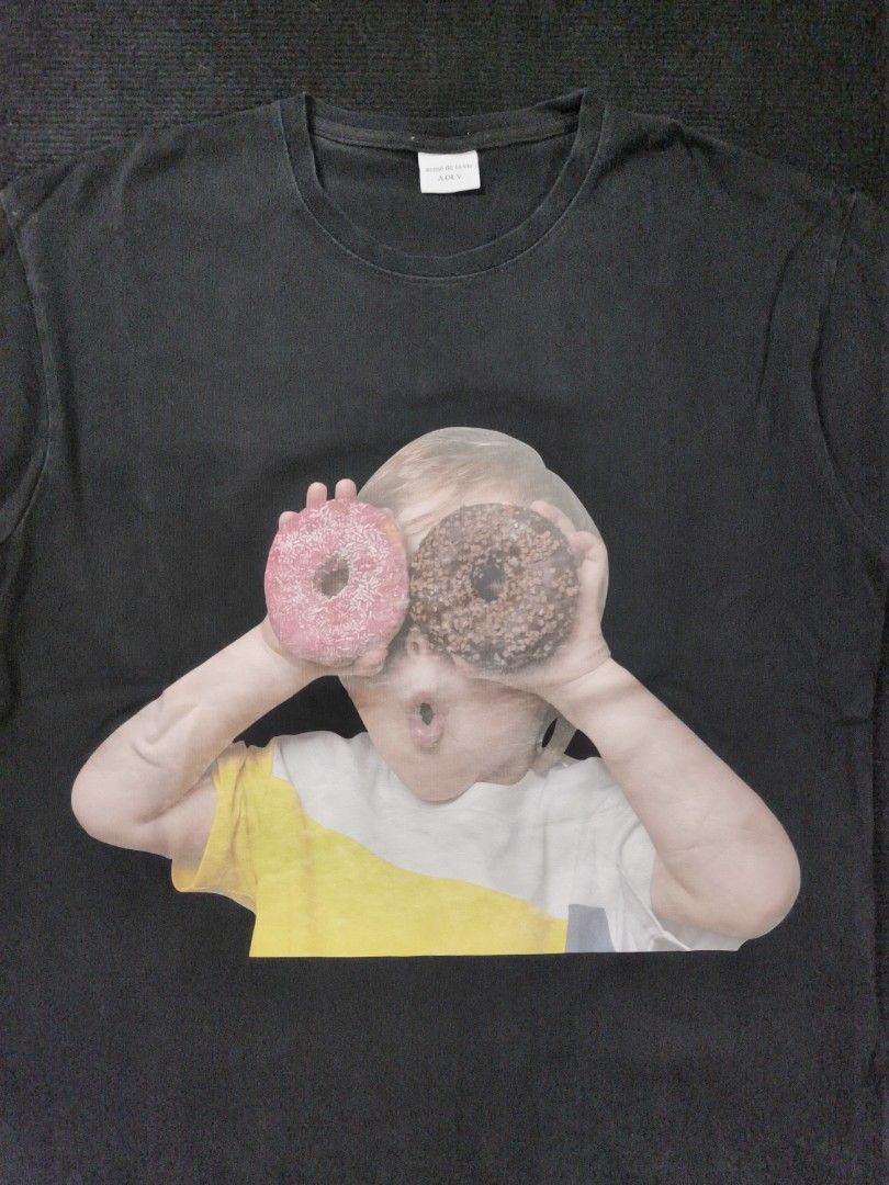 ADLV Donut kid (Category: Tshirts & Polo Shirts ) located in San Fernando. Submitted by gaboo_asncn (Listing ID 1466324781, Image 3). Description: - ADLV Donut kid - Size: Large (W22.5/L27) - Condition: Good - Color Rate: 8.5/10 - No Issue Take note: The shirt is black, and since the carpet/background is also black, the color may look slightly faded or less vibrant in the photos. In actual lighting, the shirt has a normal black color..