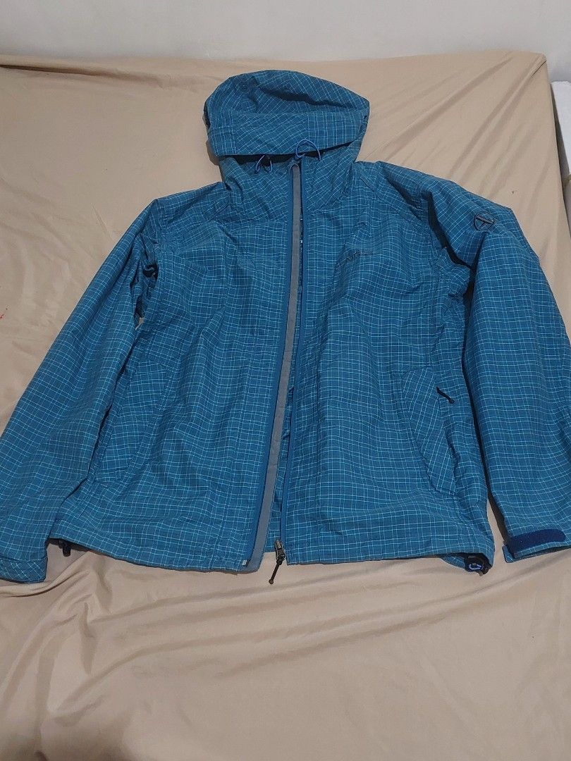 Aigle Blue Plaid Hooded Jacket Size L (Category: Coats, Jackets and Outerwear) located in Naga. Submitted by ravenmandm (Listing ID 1466278598, Image 1). Description: Blue plaid hooded jacket by Aigle. Size L on the tag. Full zip front closure with grey zipper tape. Mesh lining inside. Elastic cuffs at the sleeves. Two front pockets with zippers. Lightweight outdoor layer, easy to pack along. Issue: small hole on the hood part.
